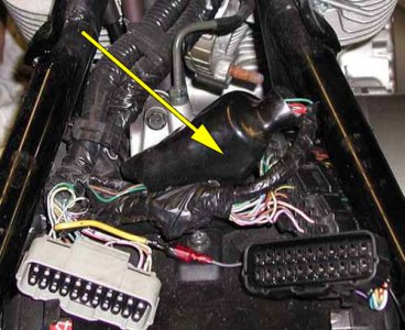 Rubber boot covering wire bundle under the seat