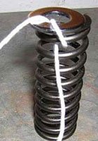 String looped around spring & washer
